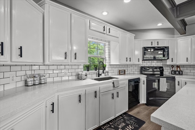 kitchen with black appliances, sink, backsplash, white cabinets, and dark hardwood / wood-style floors