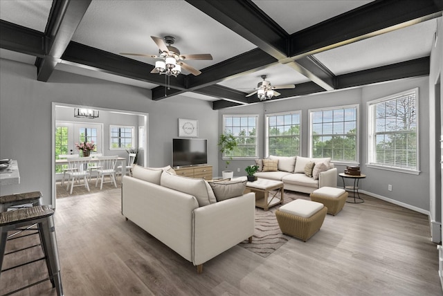 living room with beam ceiling, wood-type flooring, and ceiling fan