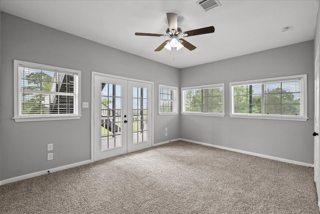 carpeted empty room with french doors and ceiling fan