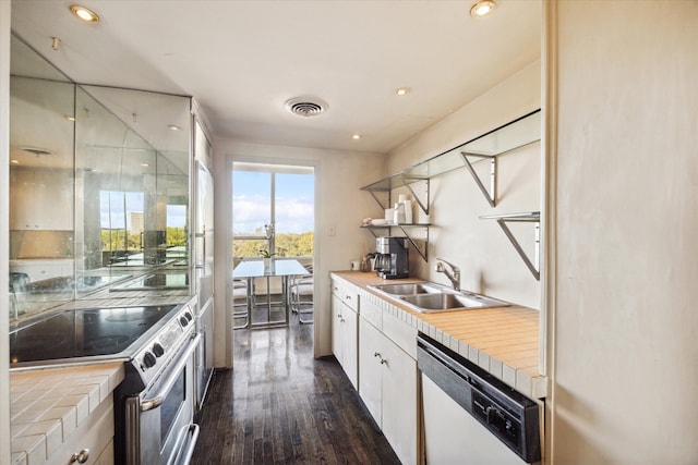 kitchen featuring sink, dark hardwood / wood-style flooring, white dishwasher, stainless steel range with electric stovetop, and white cabinets