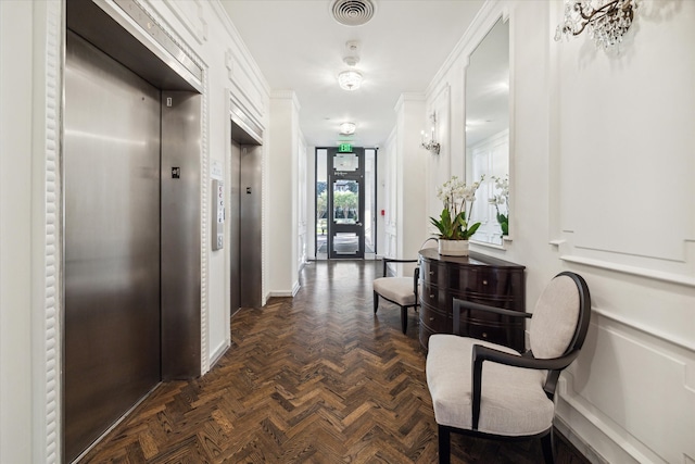 corridor with dark parquet floors, crown molding, and elevator