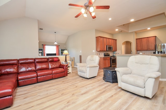 living room featuring ceiling fan, lofted ceiling, and light hardwood / wood-style flooring