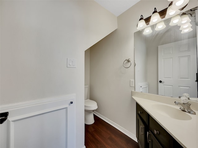 bathroom with vanity, hardwood / wood-style flooring, and toilet