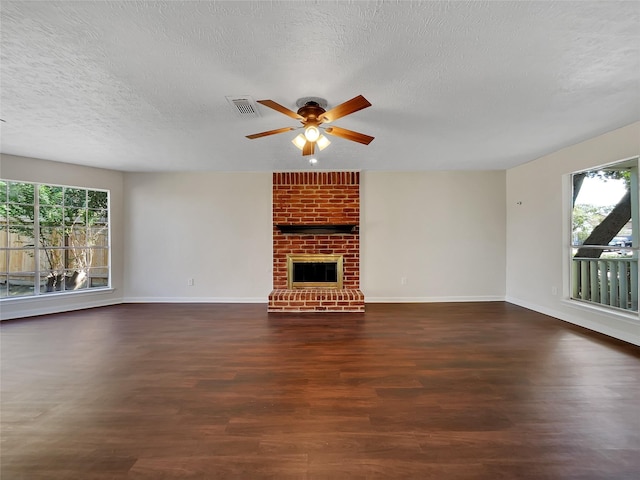 14718 W Bend Dr, Houston, TX 77082 - unfurnished living room with plenty of natural light, a ceiling fan, wood finished floors, a textured ceiling, and baseboards