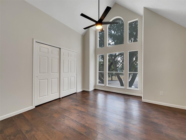 14718 W Bend Dr, Houston, TX 77082 - unfurnished bedroom featuring high vaulted ceiling, baseboards, dark wood-style flooring, and a ceiling fan