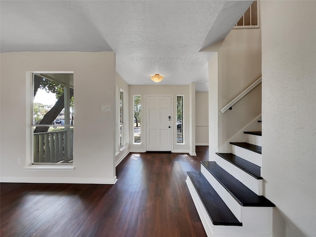 14718 W Bend Dr, Houston, TX 77082 - foyer entrance with plenty of natural light, wood finished floors, baseboards, a textured ceiling, and stairway