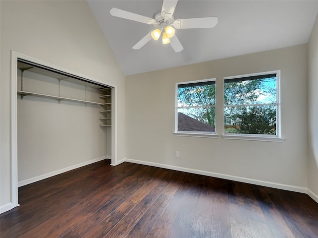 unfurnished bedroom with a closet, ceiling fan, lofted ceiling, and dark hardwood / wood-style flooring