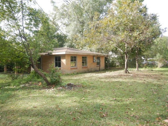 view of side of home with a lawn