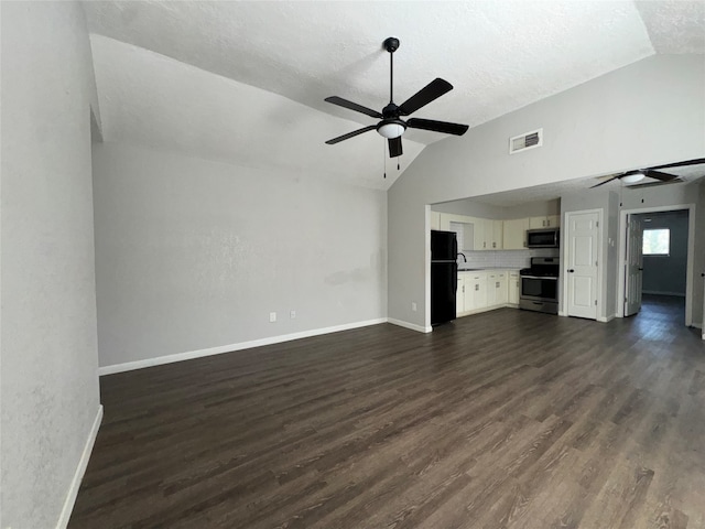 unfurnished living room with a textured ceiling, dark hardwood / wood-style floors, vaulted ceiling, and ceiling fan