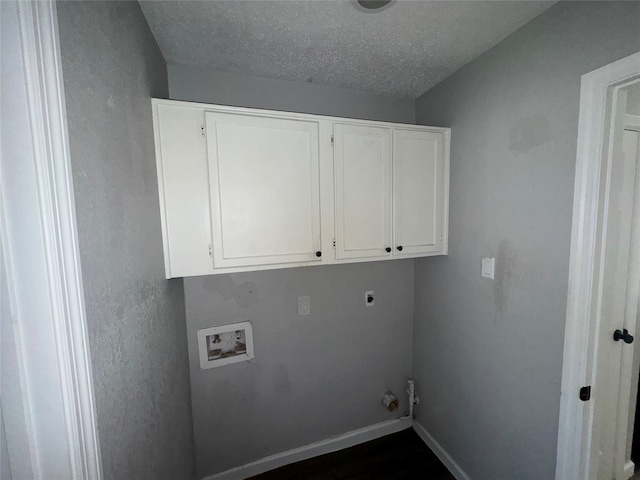 clothes washing area featuring cabinets, hookup for a washing machine, a textured ceiling, and hookup for an electric dryer