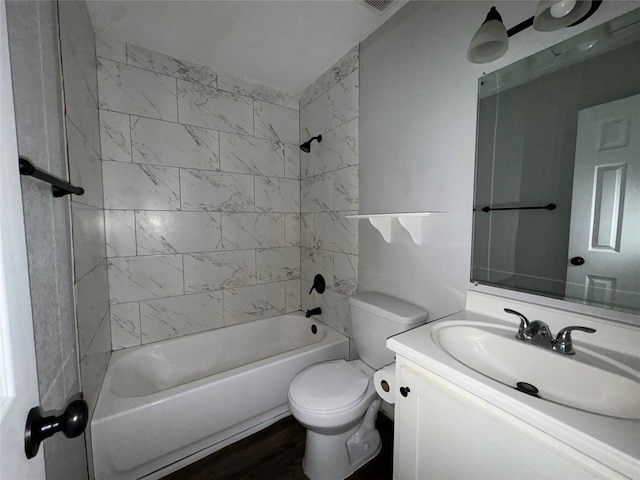 full bathroom with toilet, vanity, wood-type flooring, and tiled shower / bath