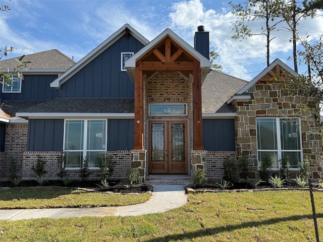 view of front of home featuring a front lawn and french doors