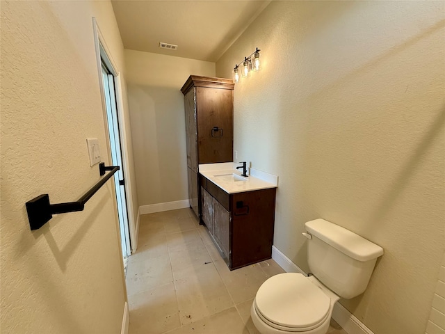 bathroom with tile patterned floors, vanity, and toilet