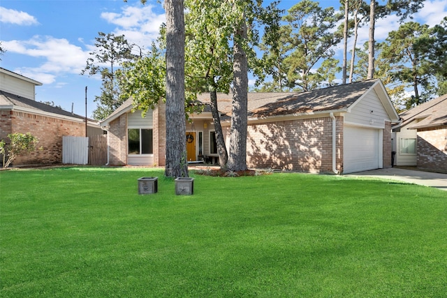 ranch-style house with a garage and a front lawn