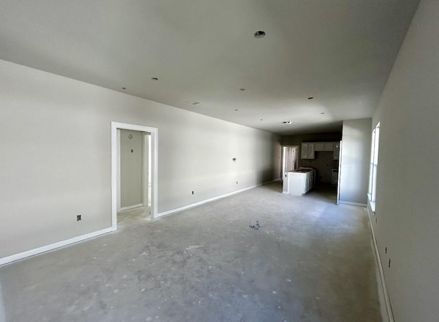 unfurnished living room with concrete floors