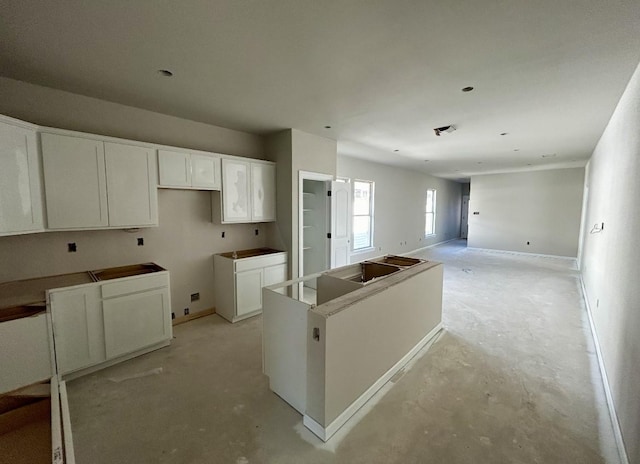 kitchen featuring a kitchen island and white cabinetry