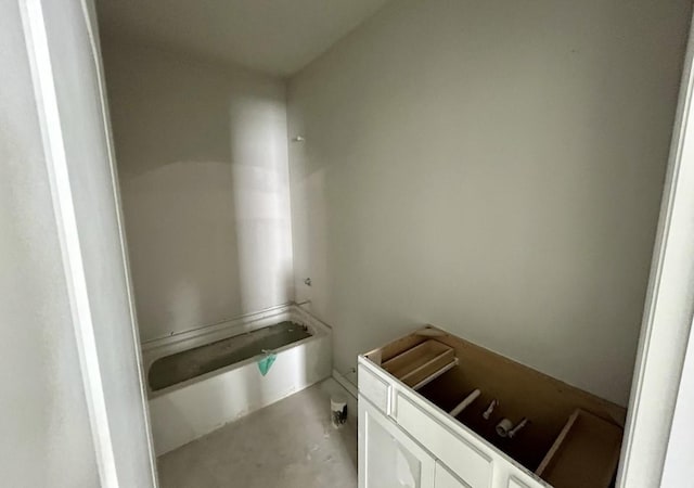 bathroom featuring a washtub and concrete flooring