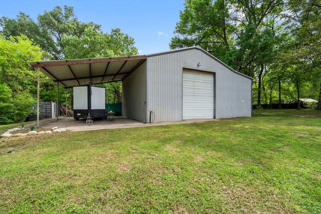 view of outdoor structure featuring a garage and a lawn