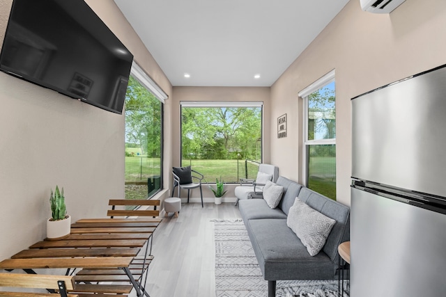 sunroom / solarium featuring a wall unit AC