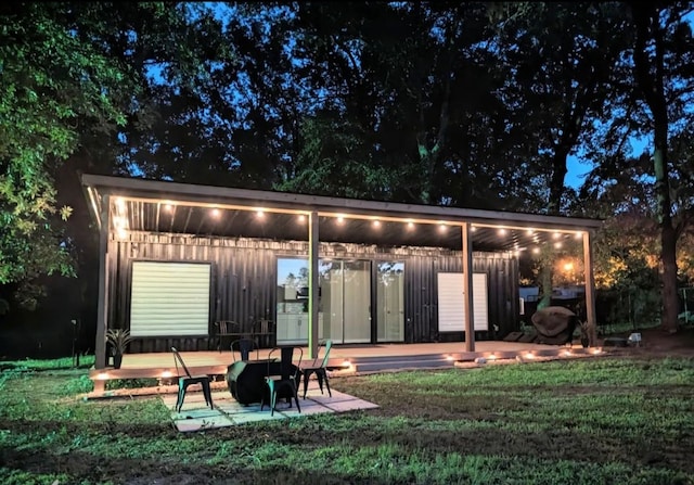 back of house featuring a patio and a yard