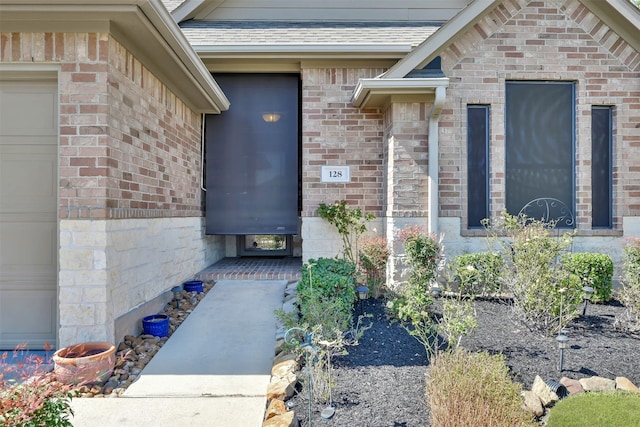 view of exterior entry featuring a garage