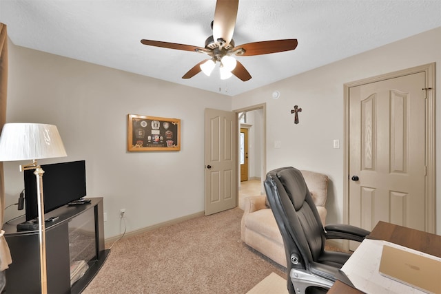 office space featuring ceiling fan and light colored carpet