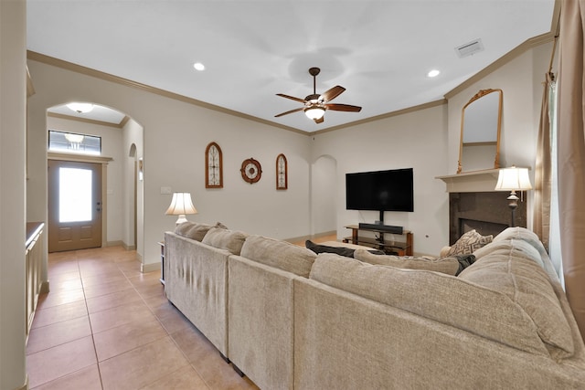 living room featuring ceiling fan, crown molding, and light tile patterned flooring