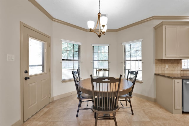 tiled dining area featuring a chandelier and ornamental molding