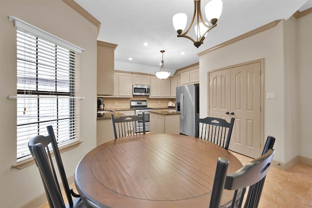 dining room featuring light tile patterned floors, plenty of natural light, a notable chandelier, and sink