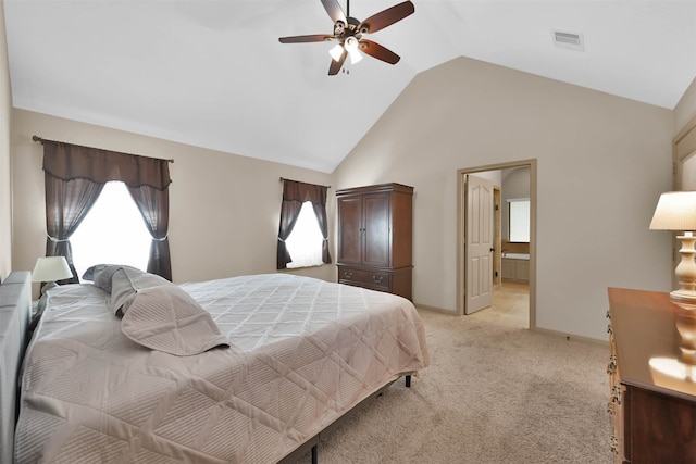 bedroom with light carpet, connected bathroom, vaulted ceiling, and ceiling fan