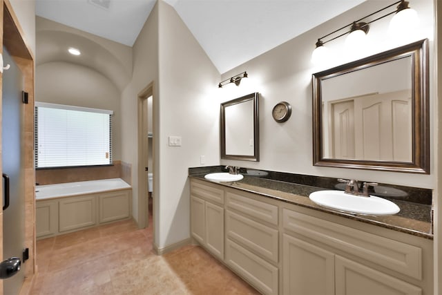 bathroom with a tub to relax in, tile patterned flooring, vanity, and vaulted ceiling