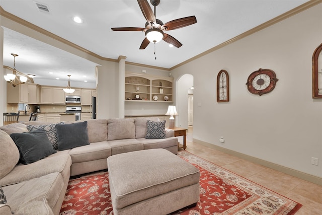 tiled living room featuring ceiling fan, sink, built in features, and ornamental molding