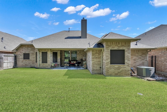 rear view of property with a patio, central AC unit, and a lawn