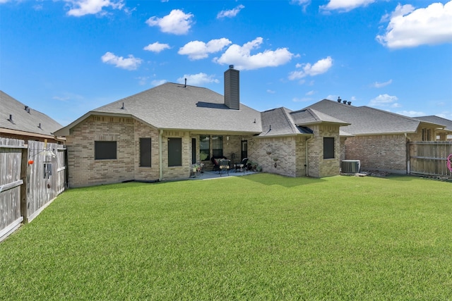 back of house featuring a lawn, central air condition unit, and a patio area