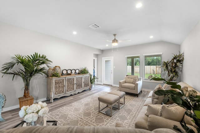 living room featuring lofted ceiling, light wood-type flooring, and ceiling fan