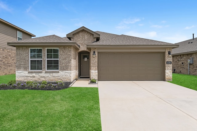 view of front facade with a front lawn and a garage