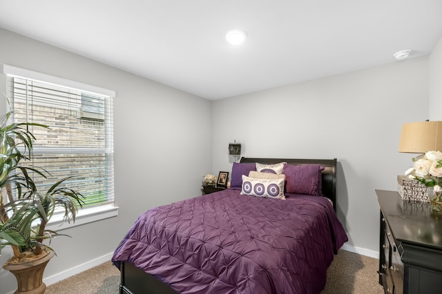 carpeted bedroom featuring multiple windows