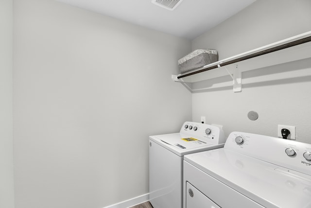 laundry room featuring independent washer and dryer and wood-type flooring