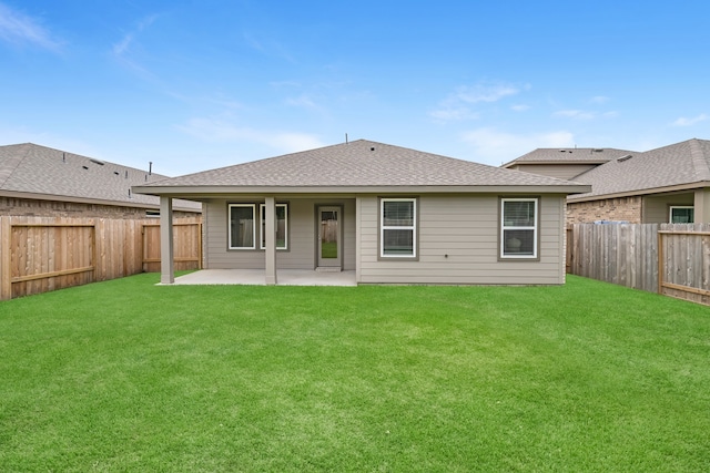 rear view of property with a patio and a yard