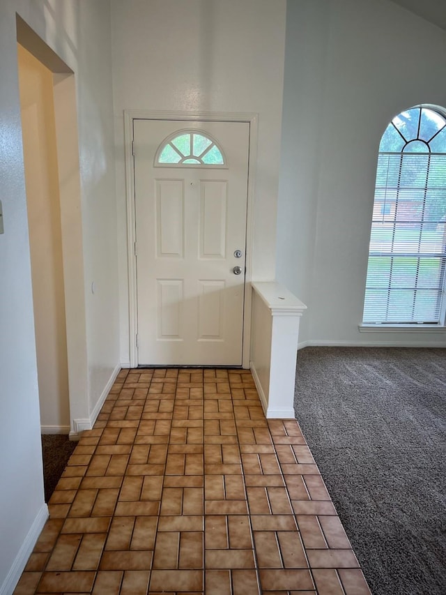 10506 Twilight Moon Dr, Houston, TX 77064 - entryway featuring baseboards, healthy amount of natural light, brick patterned floors, and light colored carpet