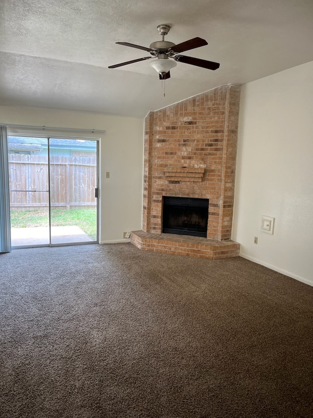 unfurnished living room featuring vaulted ceiling, a brick fireplace, a textured ceiling, and ceiling fan