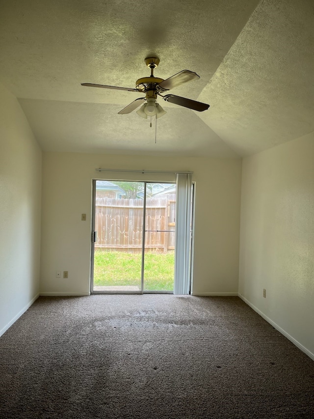 unfurnished room with carpet flooring, a textured ceiling, vaulted ceiling, and ceiling fan