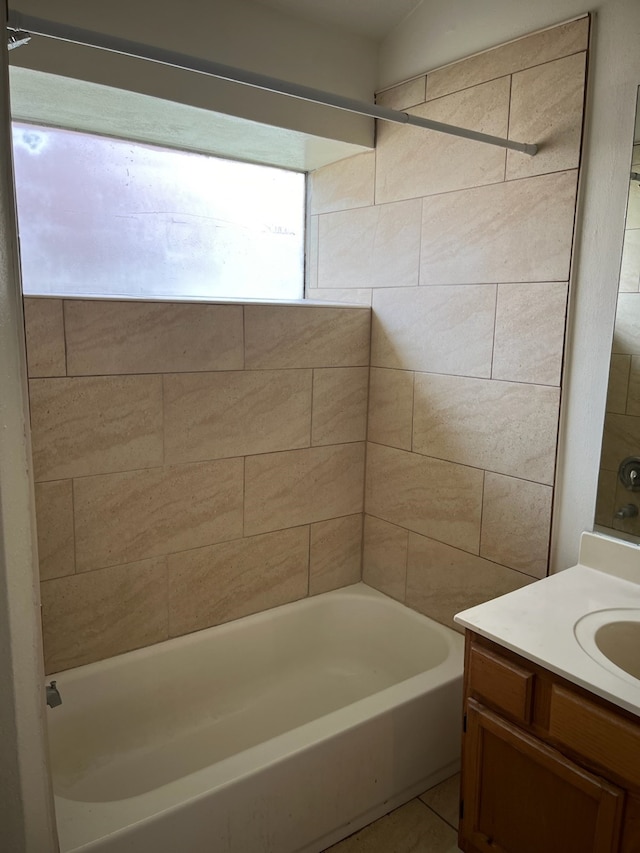 bathroom with vanity and tiled shower / bath