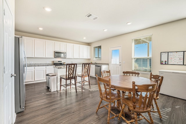 dining room with dark hardwood / wood-style floors