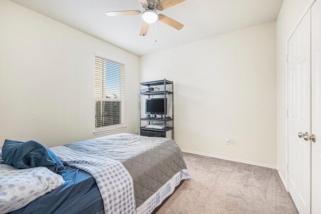 bedroom featuring light colored carpet and ceiling fan