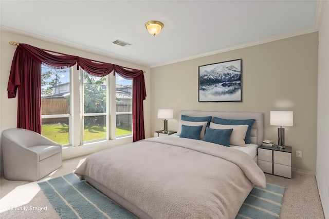 bedroom with crown molding and light colored carpet