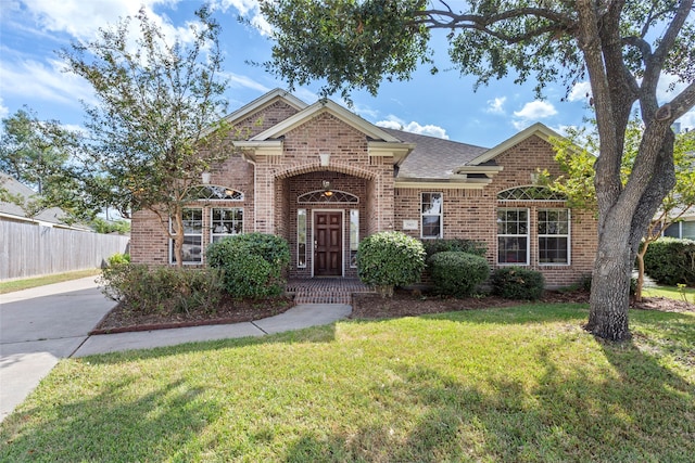 traditional-style house with brick siding and a shingled roof