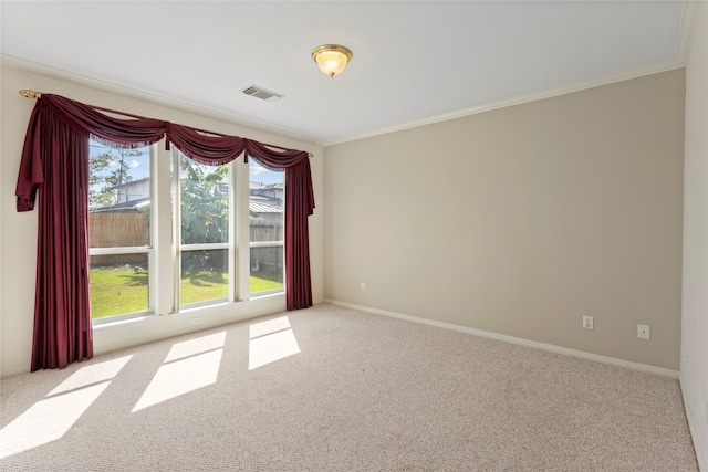 carpeted empty room with crown molding and baseboards