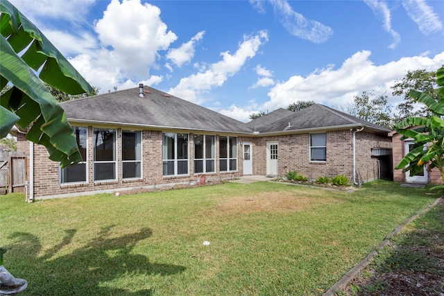 back of property with brick siding and a shingled roof
