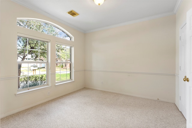 empty room featuring healthy amount of natural light, carpet, crown molding, and baseboards